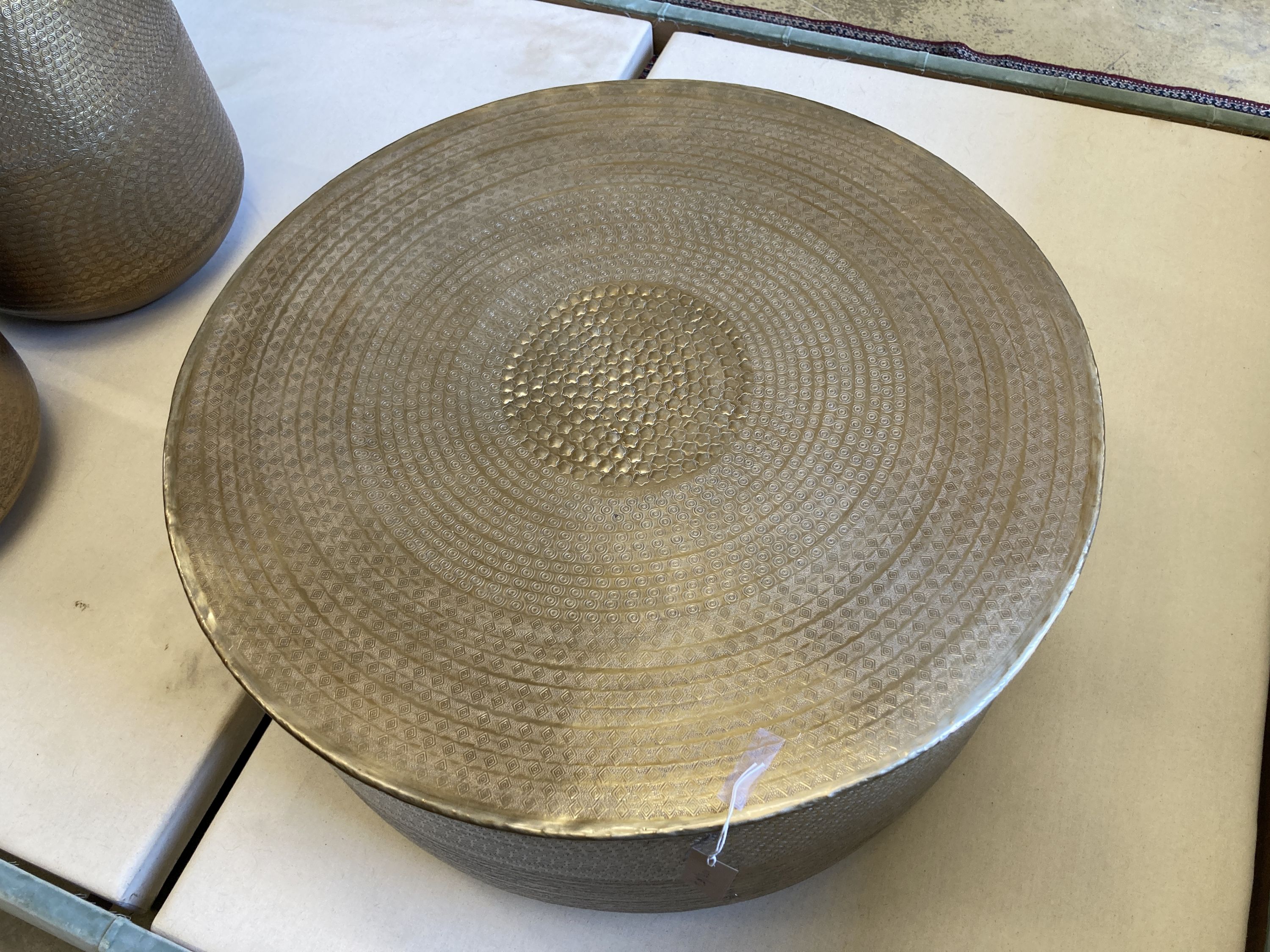 A contemporary Indian brass drum coffee table, 79cm diameter